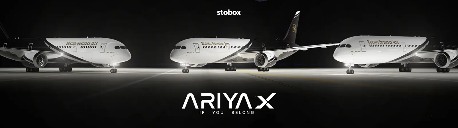 Three white Boeing Business Jets aircraft in hangar with Ariyax branding.